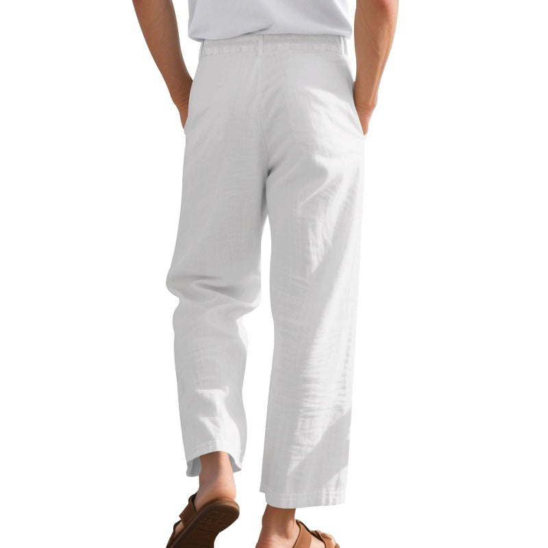 Back view of loose straight leg white linen trousers